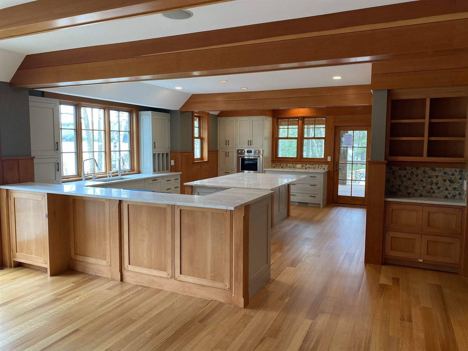 Craftsman kitchen with natural maple cabinetry, painted perimeter cabinets and a built-in hutch